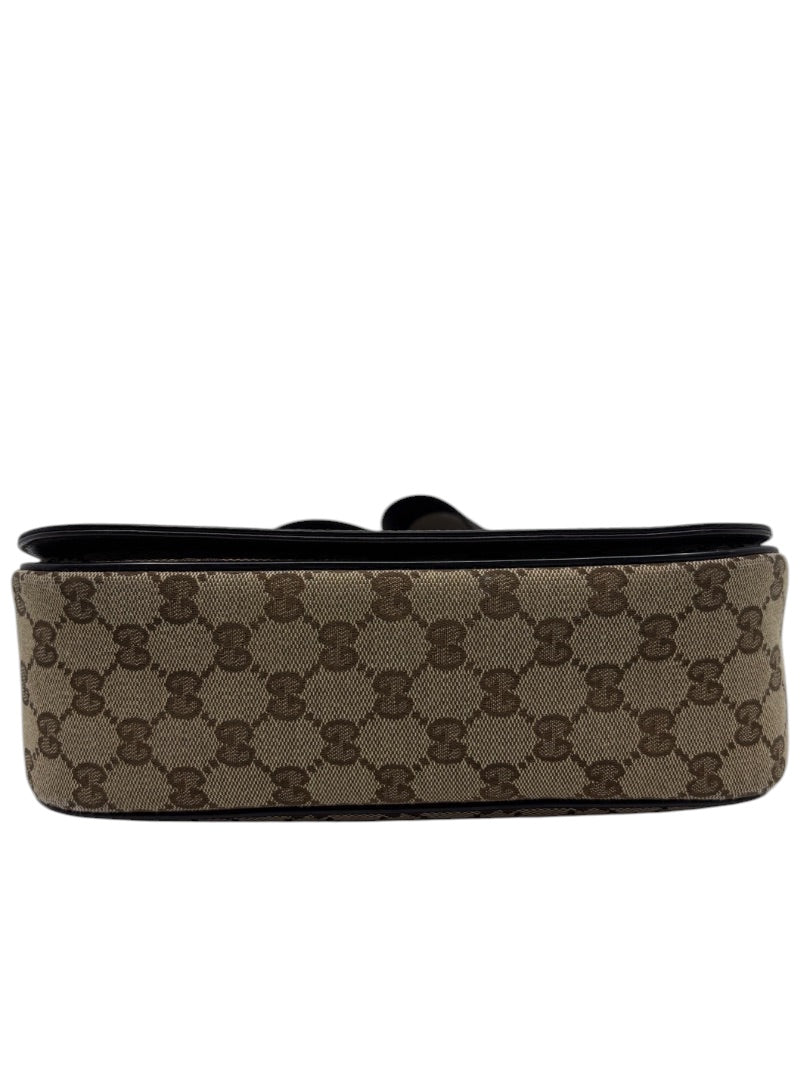 Posh Purse Co. preloved Gucci GG monogram canvas messenger bag, showing the brown patterned base and flap edge.
