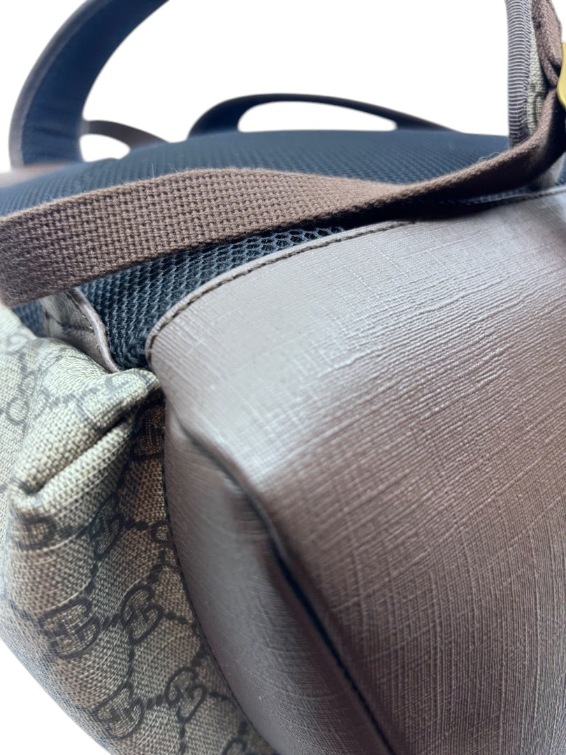 Posh Purse Co Gucci GG Supreme Ophidia backpack showing close-up of brown leather trim and monogram canvas texture