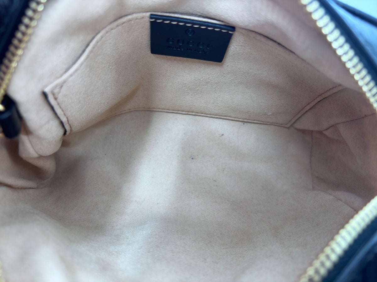 Interior of a Posh Purse Co preloved Gucci Ophidia shoulder bag with beige suede lining and leather brand tag