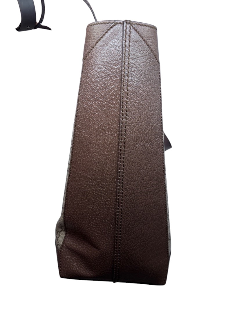 Side profile of a Posh Purse Co. Gucci Ophidia large tote bag featuring brown textured leather trim
