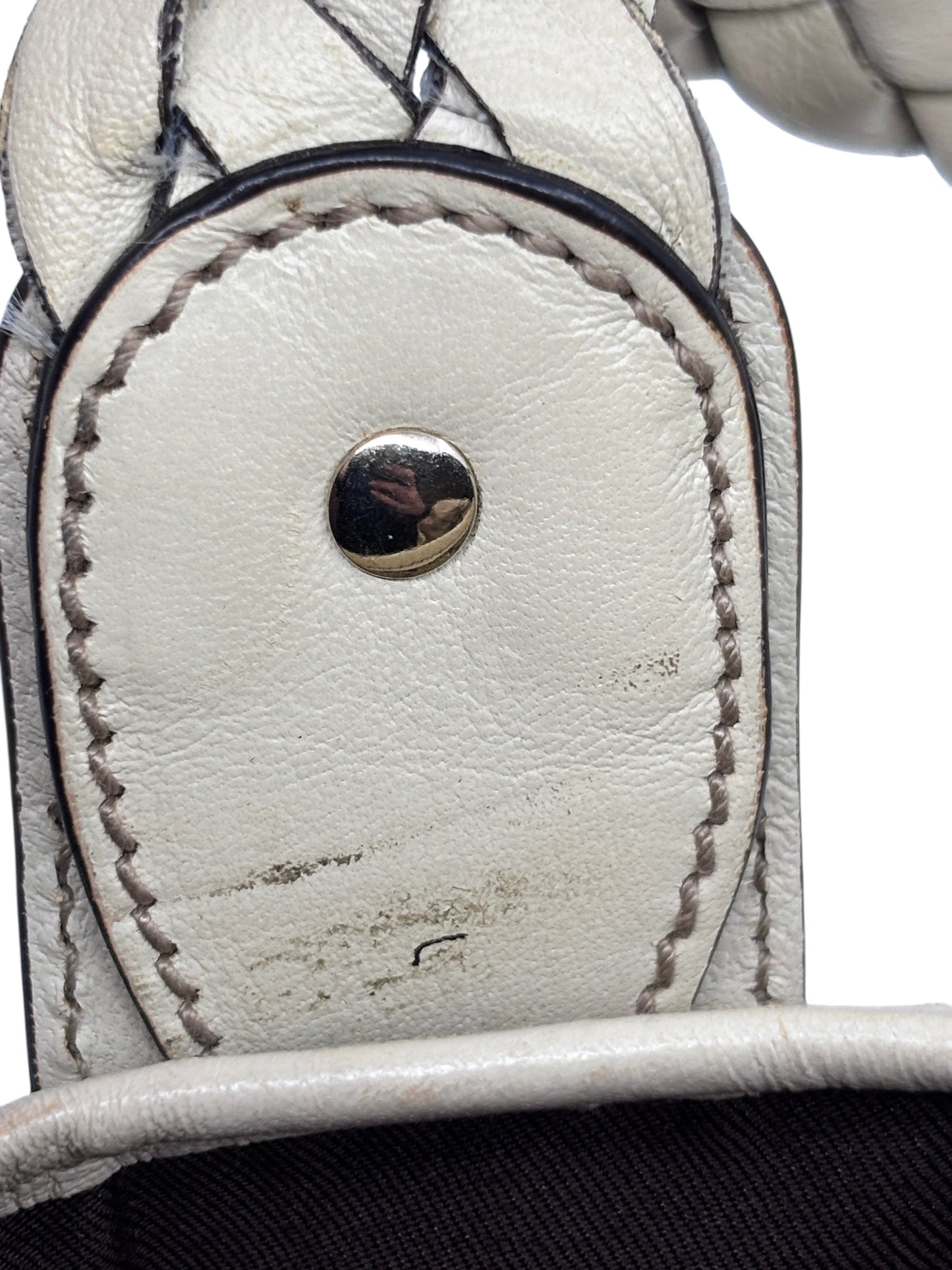 Close-up of Posh Purse Co preloved Gucci Pelham handbag showing white leather handle attachment and metal stud