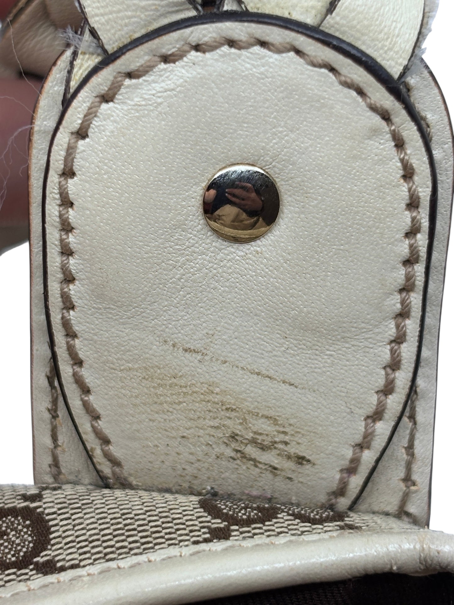 Close-up of Posh Purse Co preloved Gucci Pelham handbag showing white leather trim with visible wear and stitching.