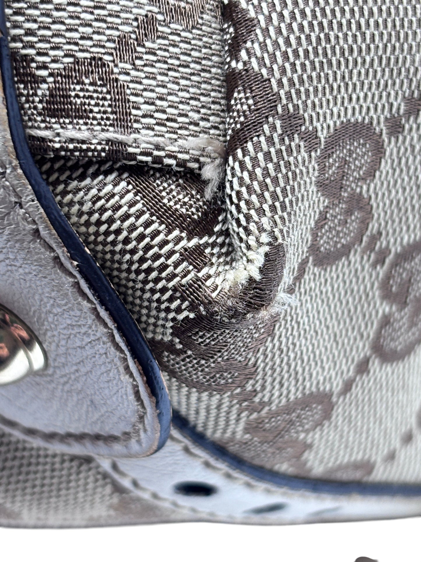 Close-up of Posh Purse Co preloved Gucci Pelham handbag showing monogram canvas texture and minor corner wear