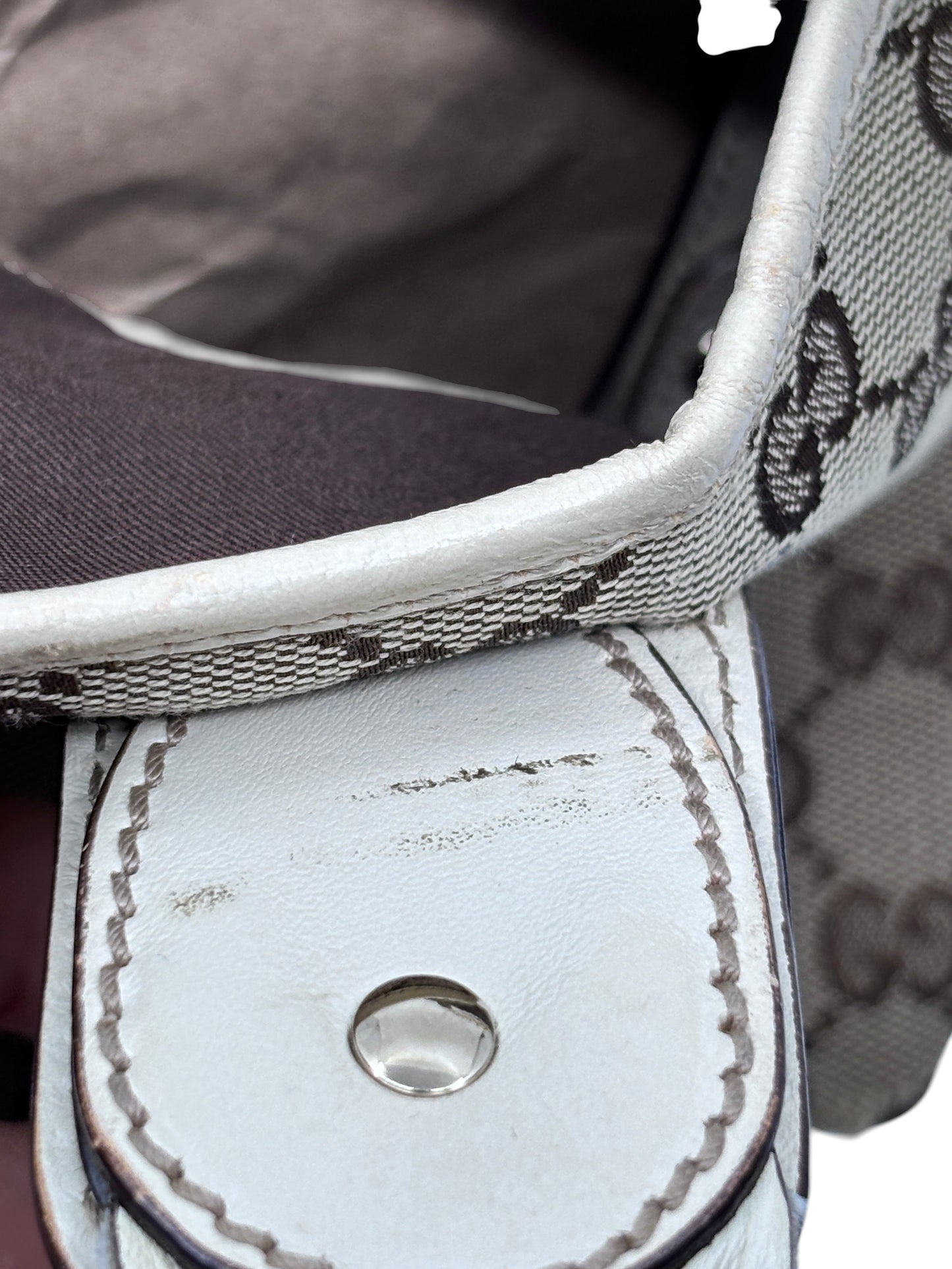 Close-up of Posh Purse Co preloved Gucci Pelham handbag showing monogram canvas, white leather trim, and stitching.