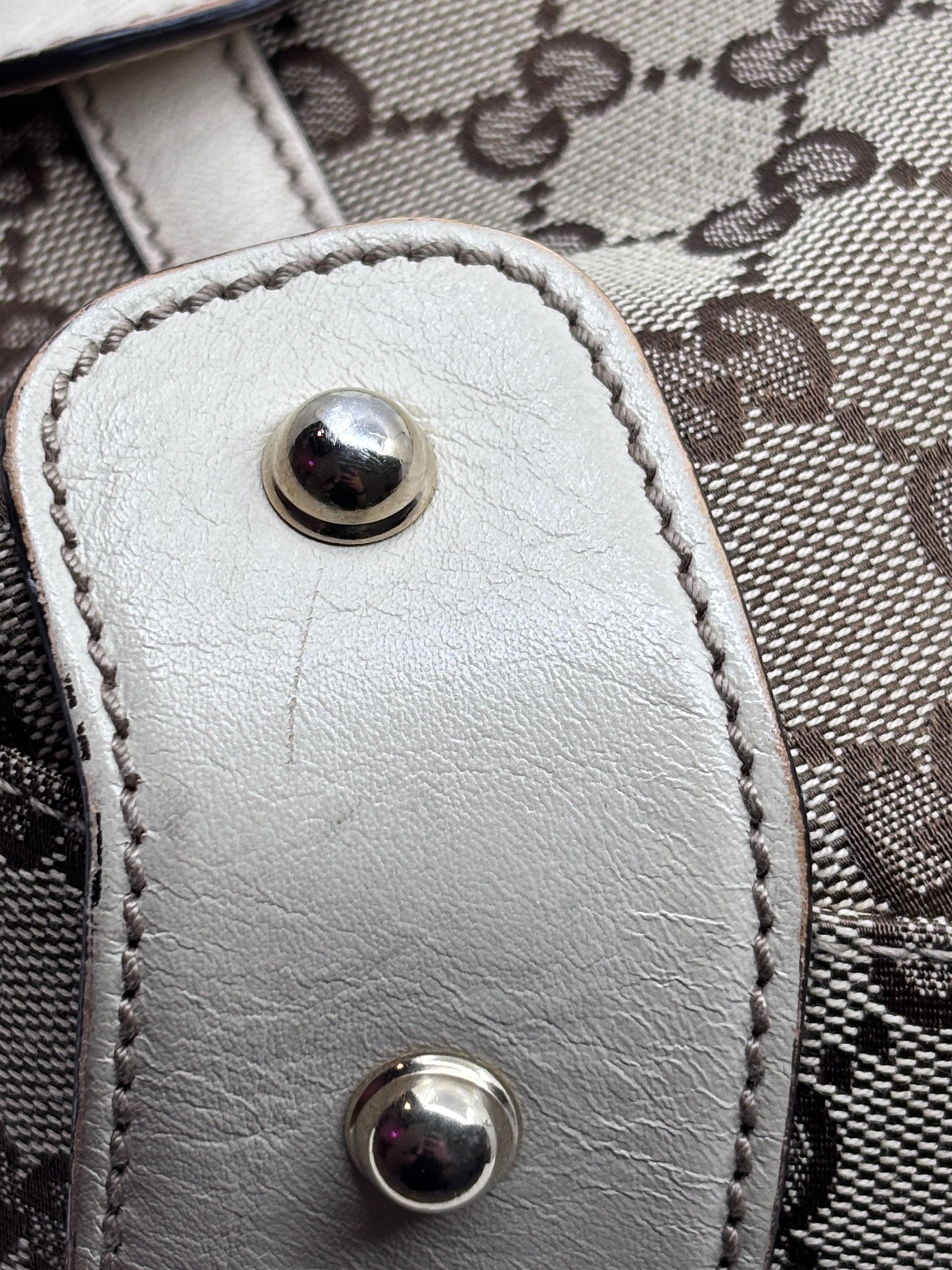Close-up of Posh Purse Co preloved Gucci Pelham handbag featuring beige monogram canvas and white leather trim