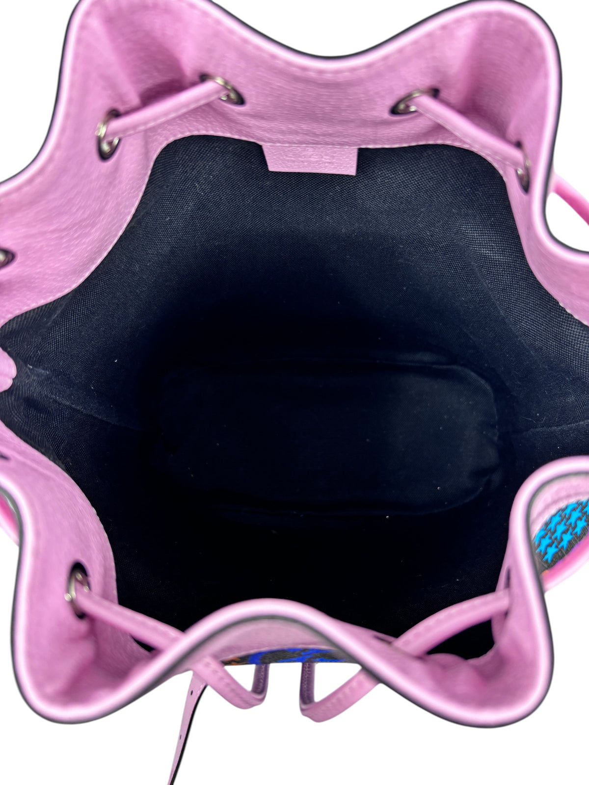 Interior view of a pink Posh Purse Co. Gucci GG Psychedelic bucket bag with a black fabric lining