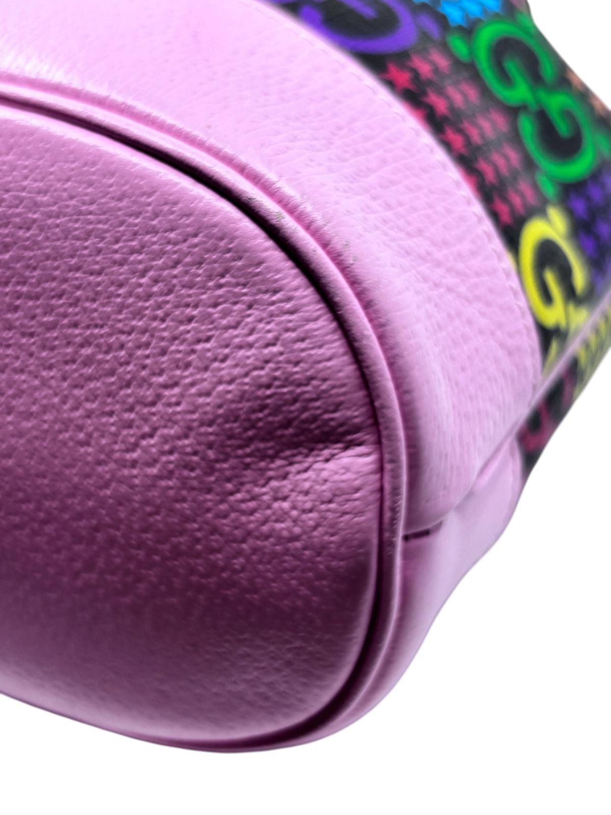 Posh Purse Co. pink leather base of a Gucci GG Psychedelic bucket bag featuring textured grain detail.