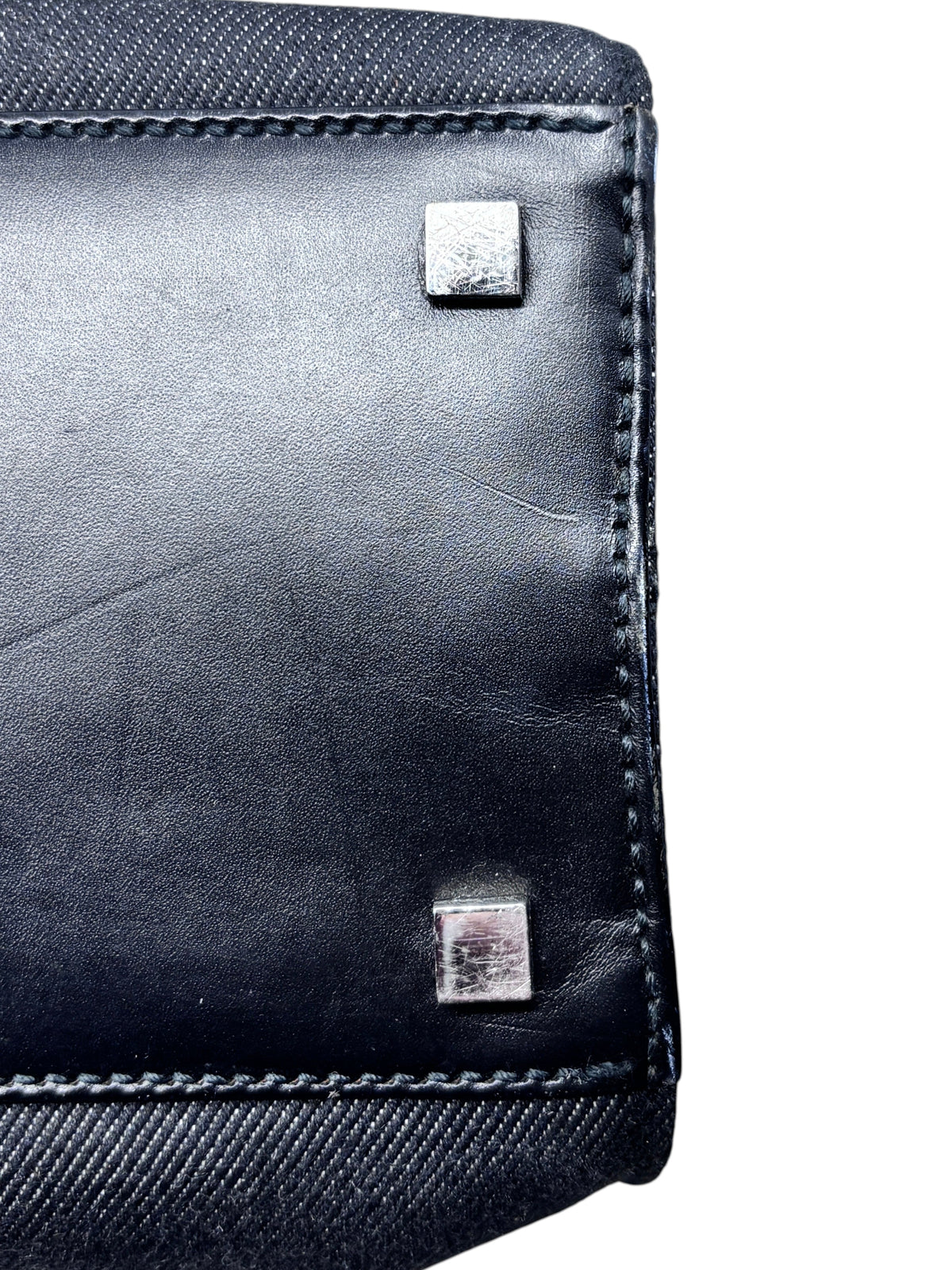 Posh Purse Co. vintage Gucci shopper tote showing the black leather base with protective metal feet and stitching.