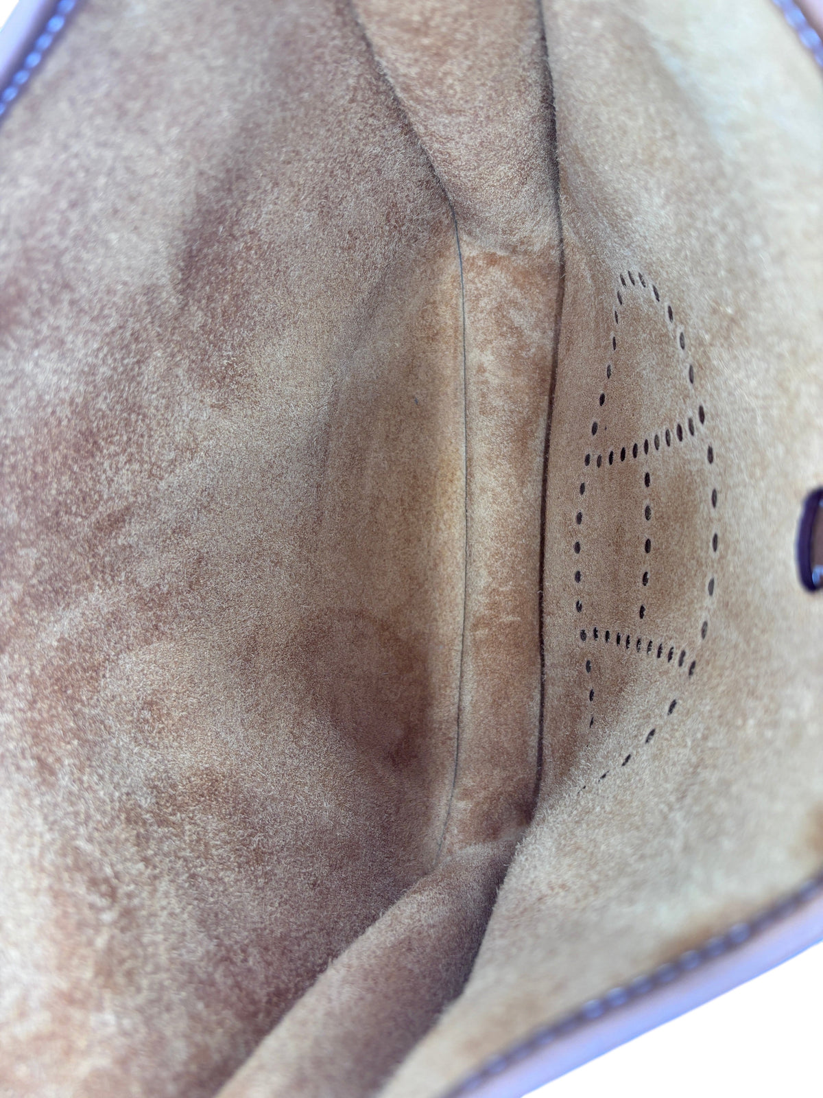 Interior of a brand new Posh Purse Co Hermès Evelyne bag in gold leather showing the perforated H logo detail