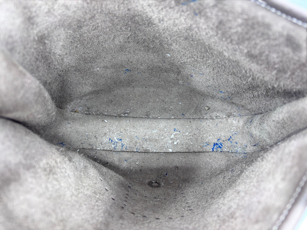 Interior of Posh Purse Co. preloved Hermes Evelyne PM bag showing grey suede lining with minor pen marks and staining