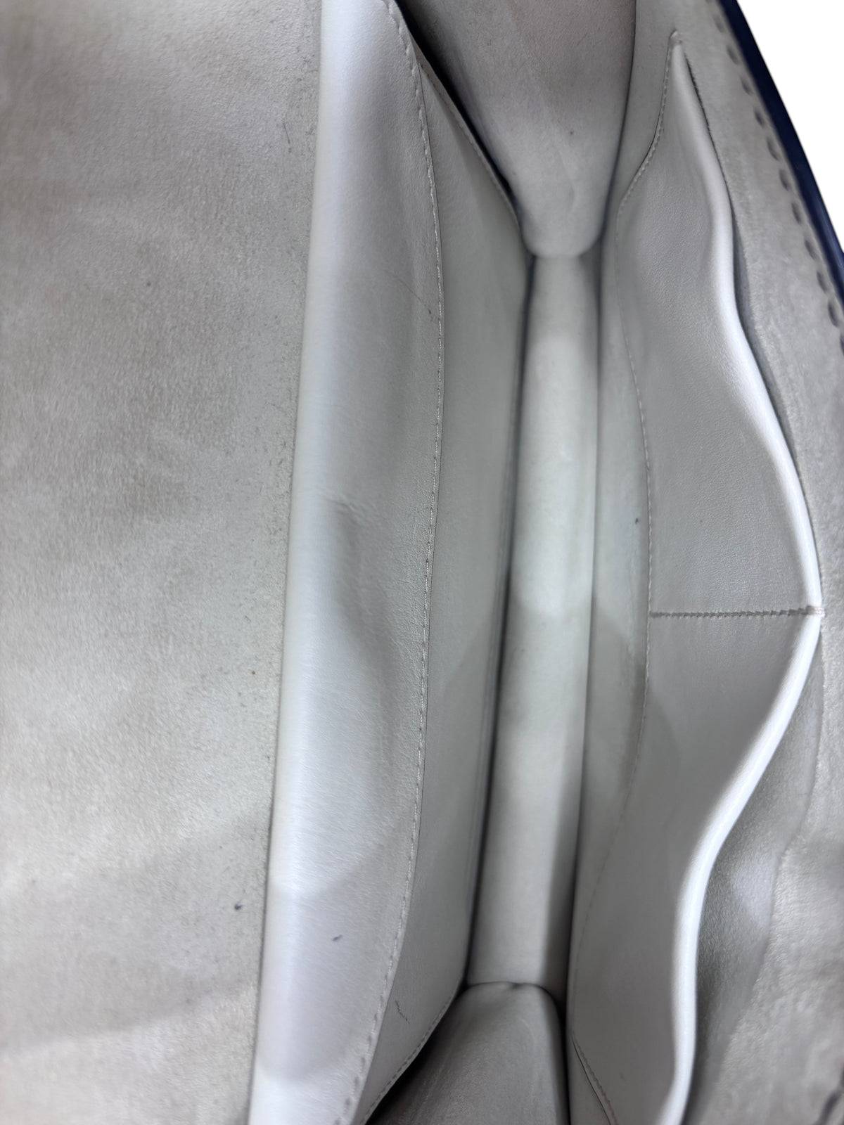 Interior of Posh Purse Co ivory Dior J'adior chain flap bag showing suede lining and slip pocket