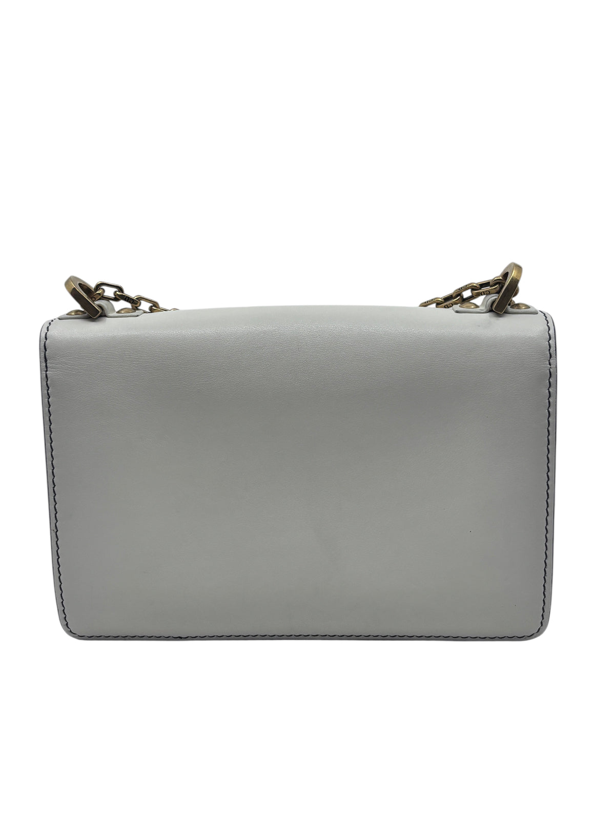Back view of a Posh Purse Co ivory Dior J'adior chain flap bag with gold-tone hardware against a white background.