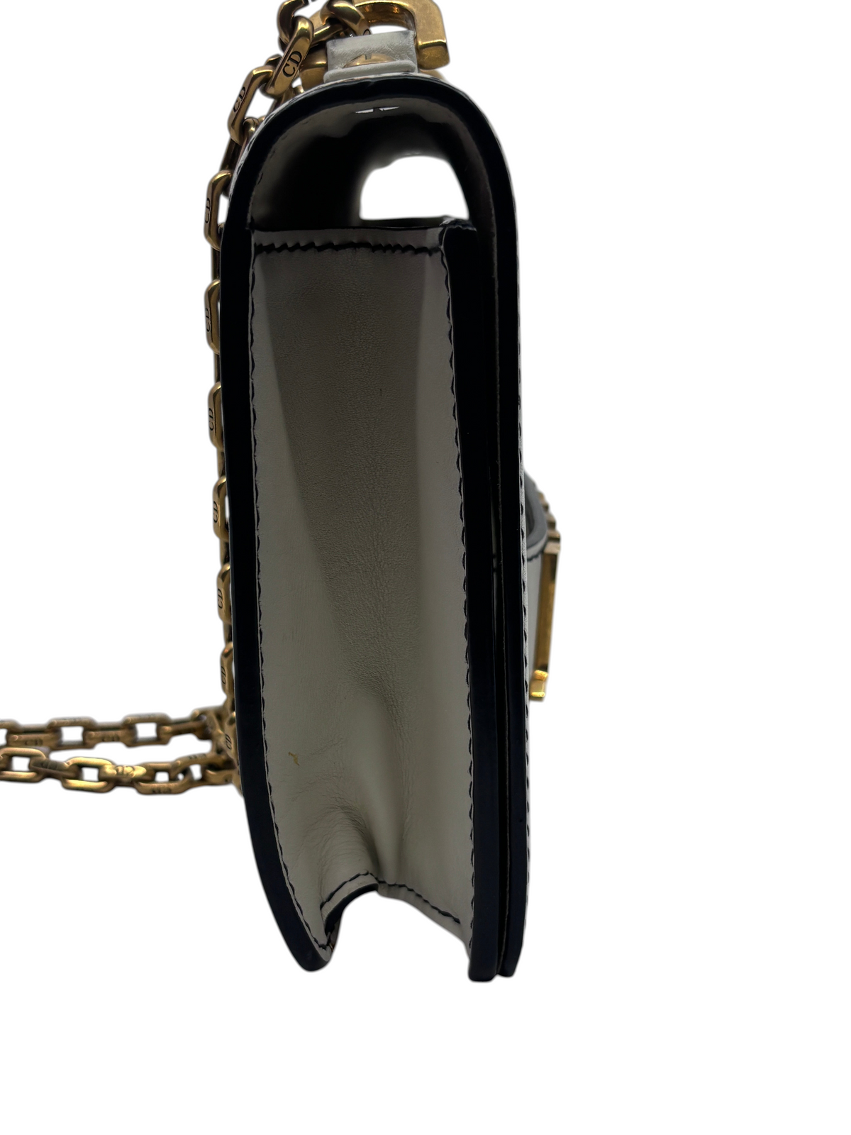 Side view of Posh Purse Co ivory Dior J'adior chain flap bag showing leather gusset and gold chain shoulder strap
