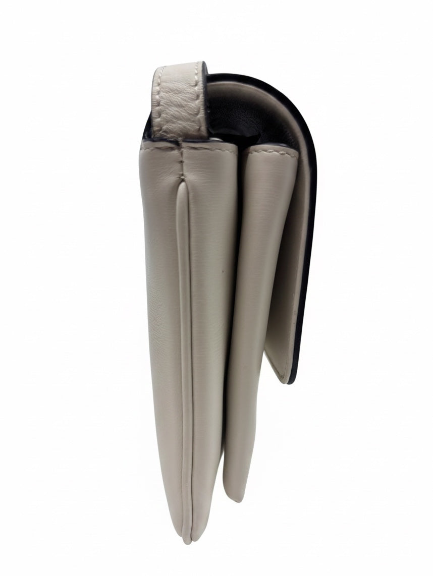 Side profile of a Posh Purse Co ivory Gucci Arli leather handbag showing the structured silhouette and flap closure