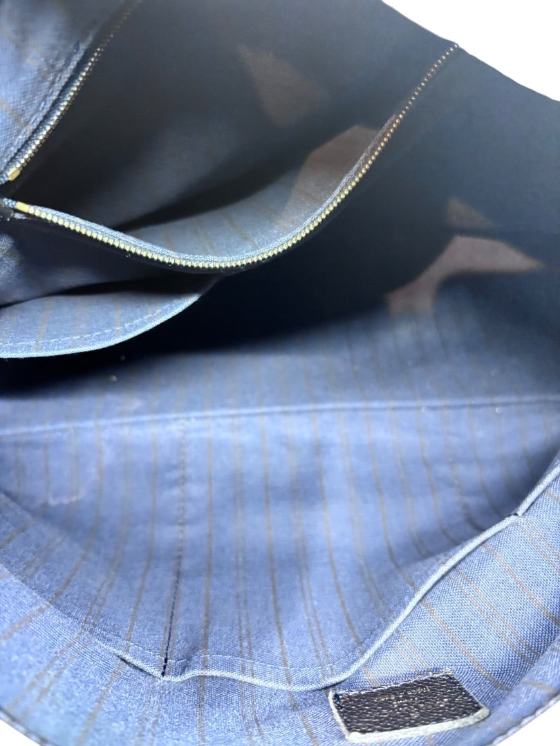 Interior of Posh Purse Co Louis Vuitton Artsy MM handbag featuring blue striped fabric lining and zipper pocket
