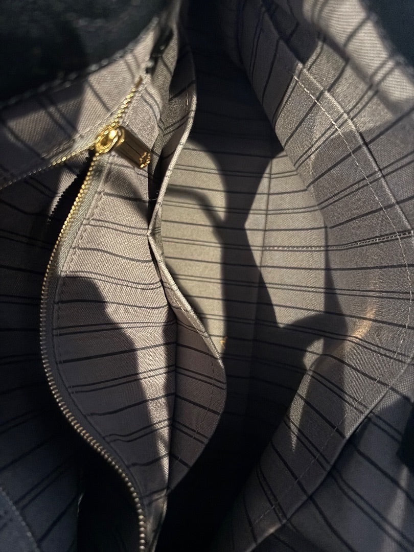 Posh Purse Co Louis Vuitton Artsy MM black leather hobo bag interior with striped lining and gold-tone zipper.