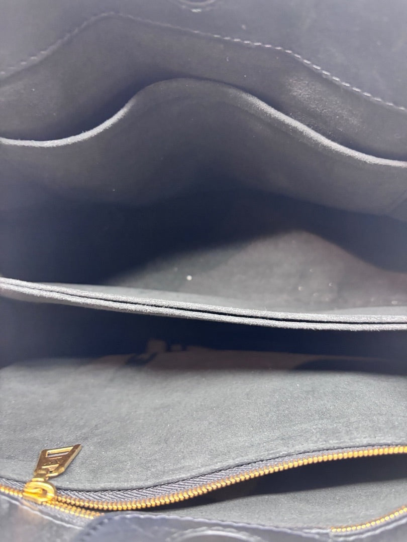 Interior view of a black Louis Vuitton New Wave Chain Bag featuring a suede-like lining from Posh Purse Co