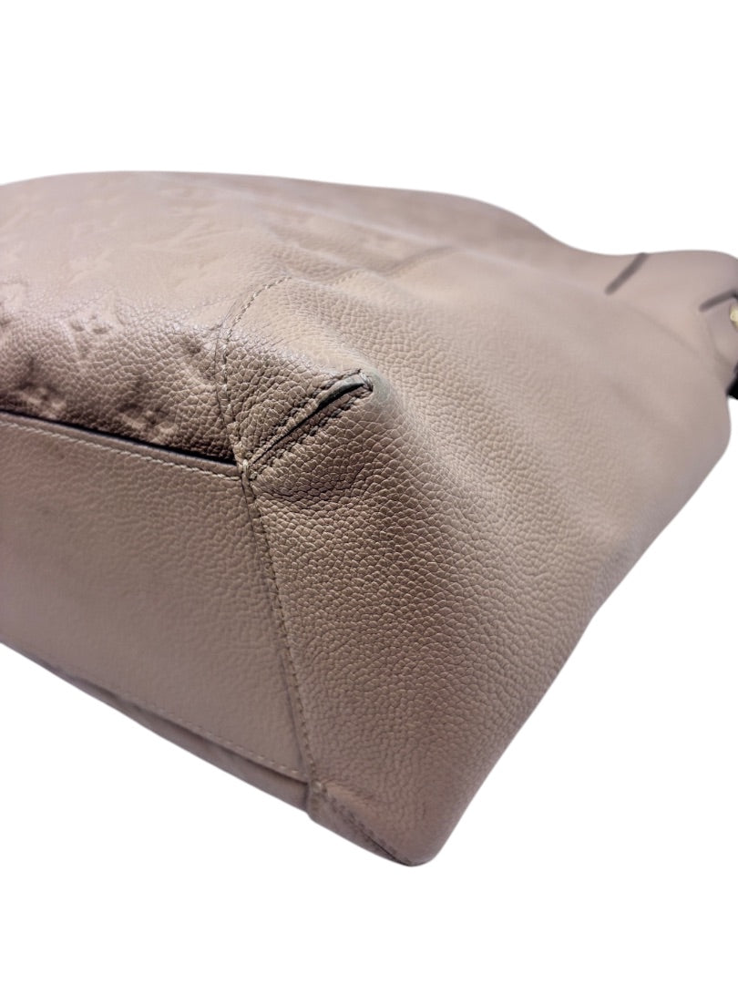 Posh Purse Co tan Louis Vuitton Empreinte Bagatelle hobo bag corner detail showing embossed monogram leather