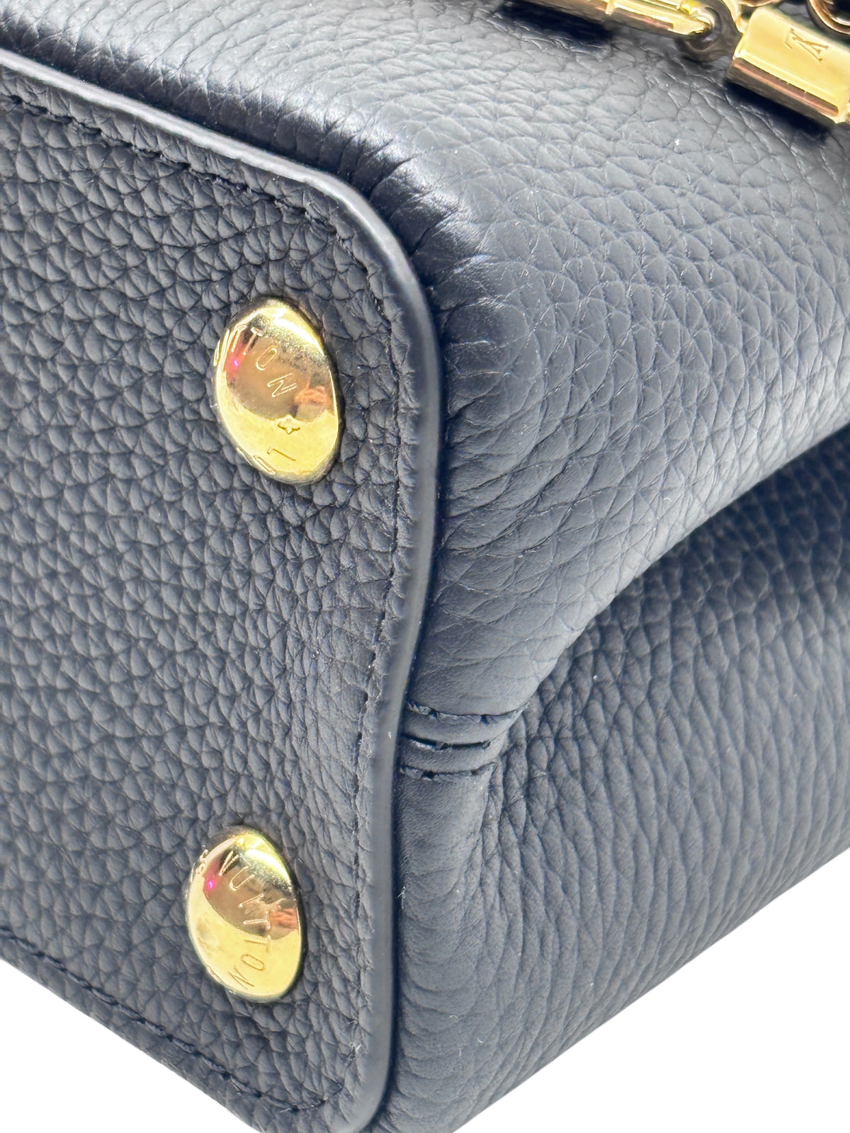 Close-up of Posh Purse Co black leather Louis Vuitton Capucines BB handbag showing gold-tone hardware studs