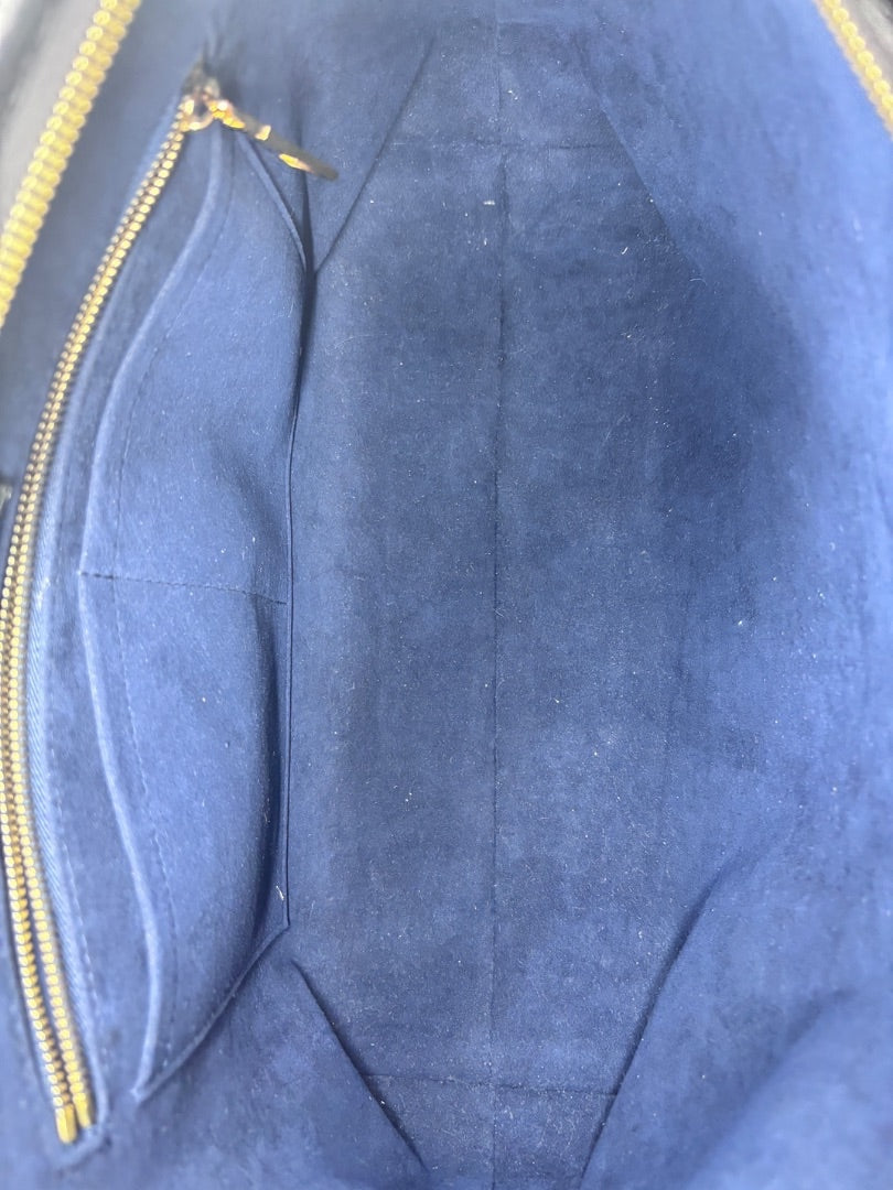 Posh Purse Co interior view of a black Louis Vuitton CarryAll handbag featuring a luxurious blue suede lining.