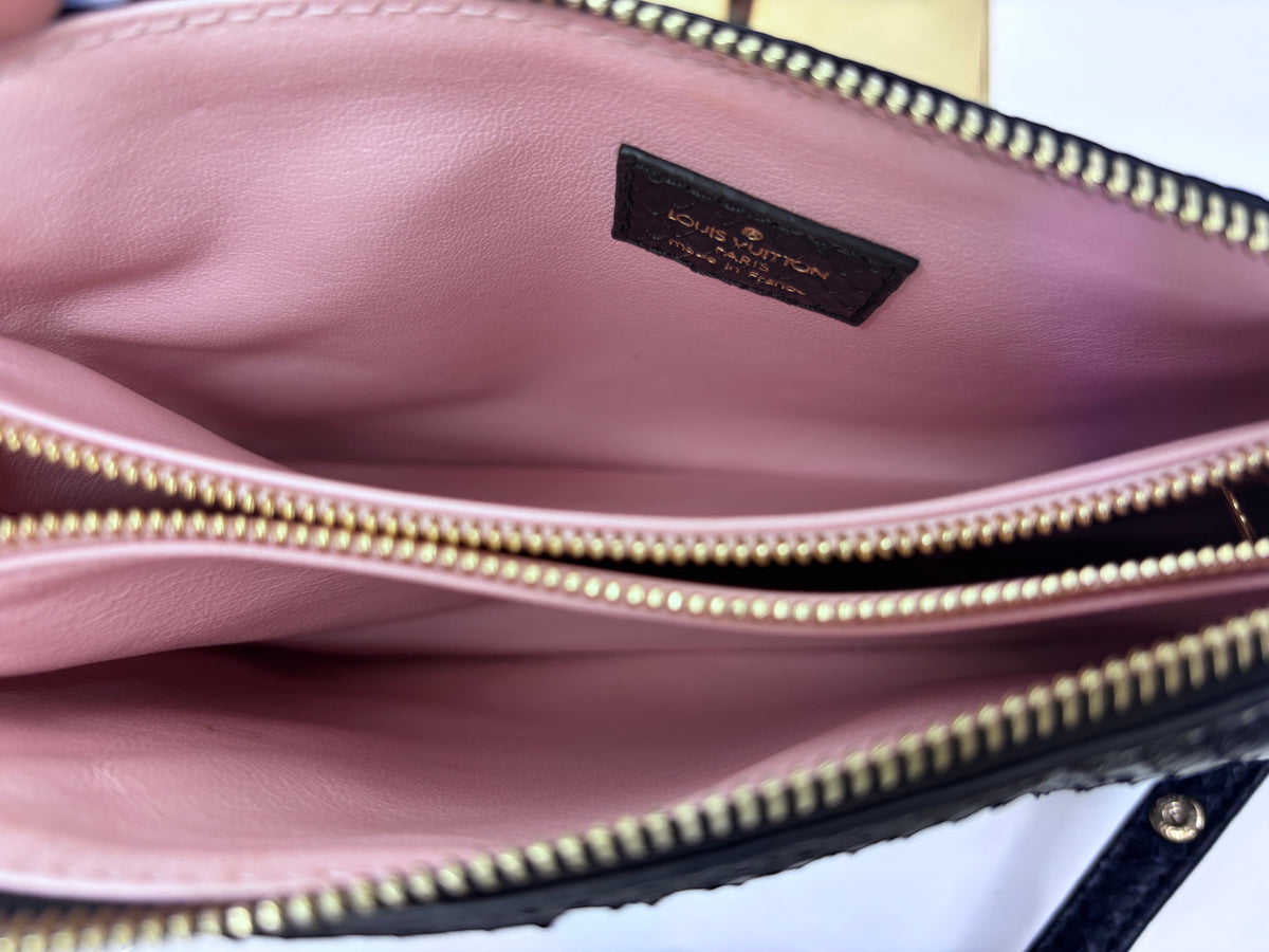 Interior of Posh Purse Co black Louis Vuitton Coussin BB handbag featuring soft pink lining and gold zipper details