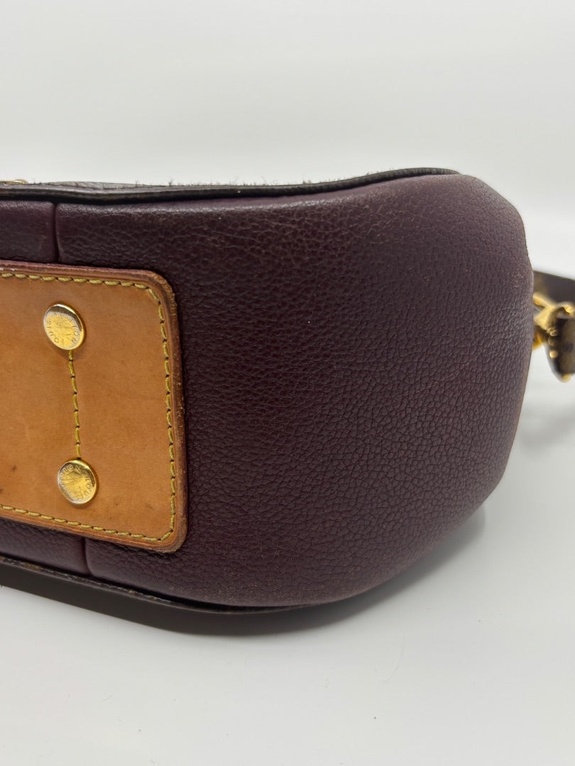 Posh Purse Co. Louis Vuitton Eden MM bag base with purple leather, tan trim, and gold-tone protective feet.