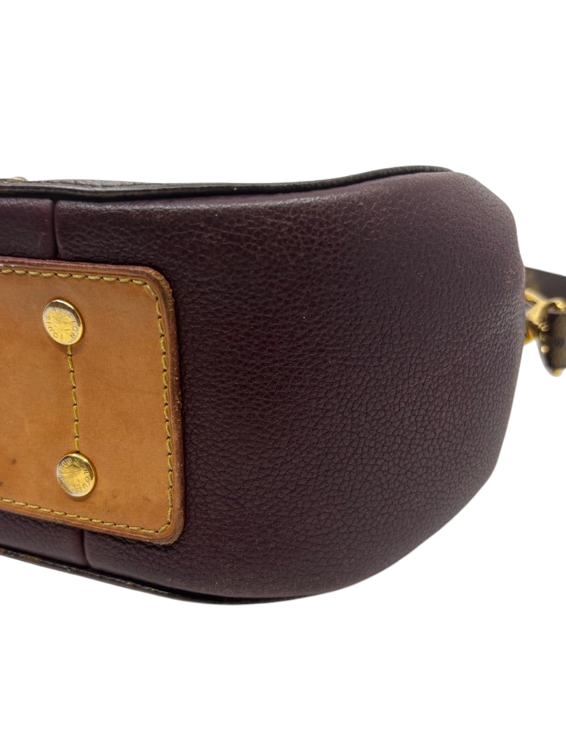 Posh Purse Co. Louis Vuitton Eden MM bag base with purple leather, tan trim, and gold-tone protective feet.