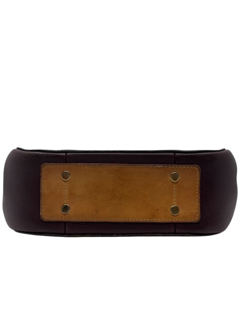 Base of preloved Louis Vuitton Eden MM bag from Posh Purse Co. featuring brown leather and gold-tone protective feet.