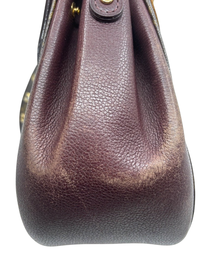 Side view of Posh Purse Co. preloved Louis Vuitton Eden MM bag featuring textured brown leather side panel.
