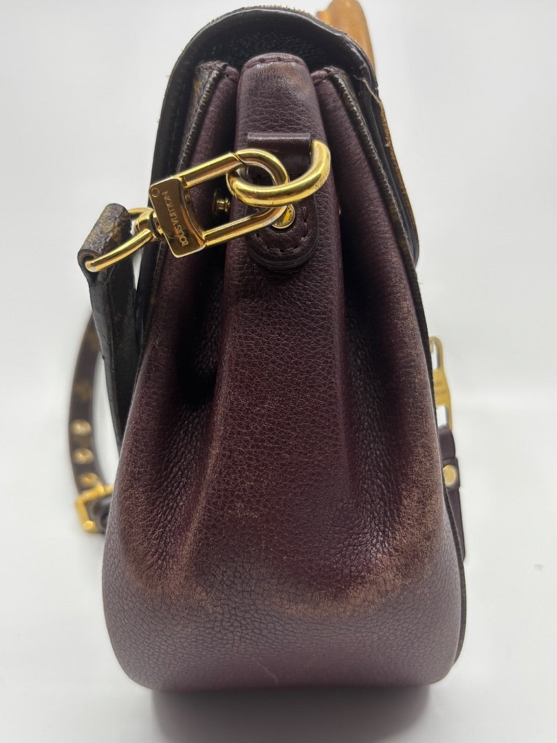 Side view of preloved Louis Vuitton Eden MM bag with brown leather trim and gold hardware from Posh Purse Co.