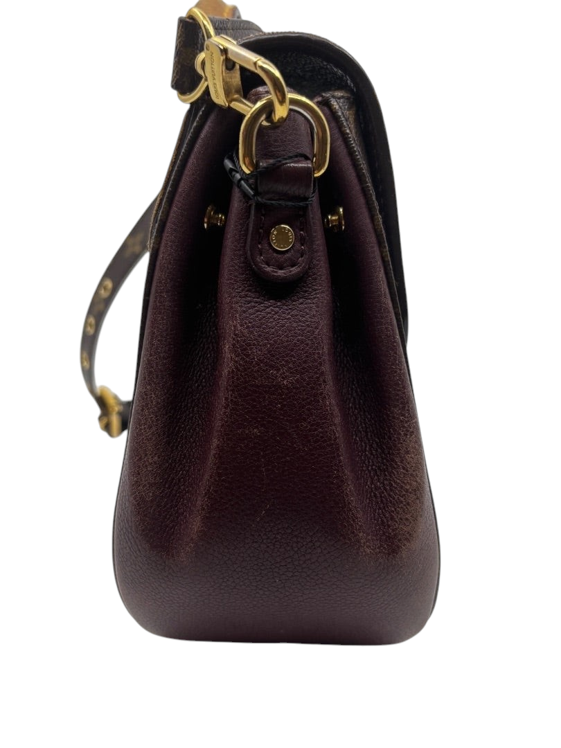 Side profile of Posh Purse Co. Louis Vuitton Eden MM bag in brown monogram canvas with dark leather and gold hardware