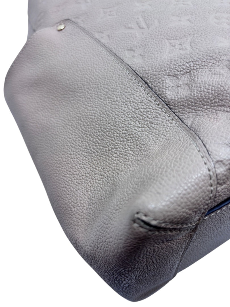 Posh Purse Co tan Louis Vuitton Empreinte Bagatelle hobo bag showing embossed monogram leather and corner detail
