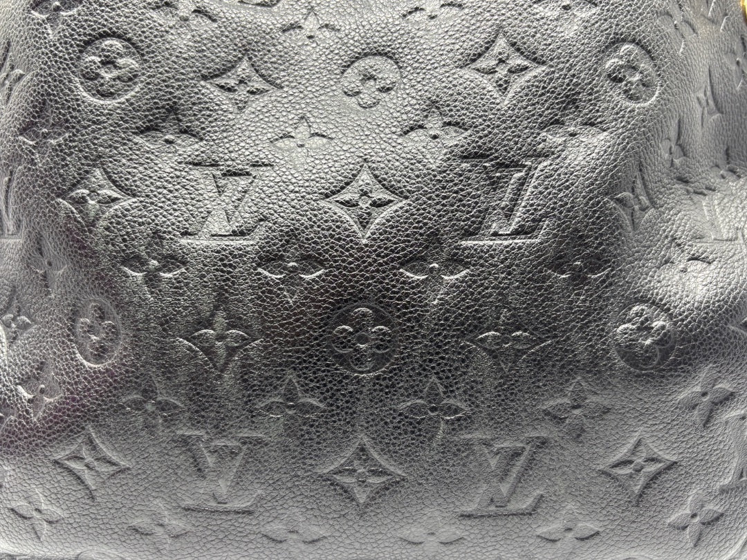 Close-up of black Monogram Empreinte leather on a Posh Purse Co. Louis Vuitton Spontini handbag.