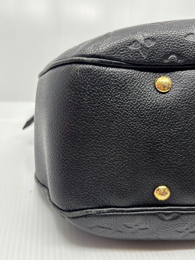 Posh Purse Co. black Louis Vuitton Empreinte Spontini handbag base with gold protective feet and embossed monogram.