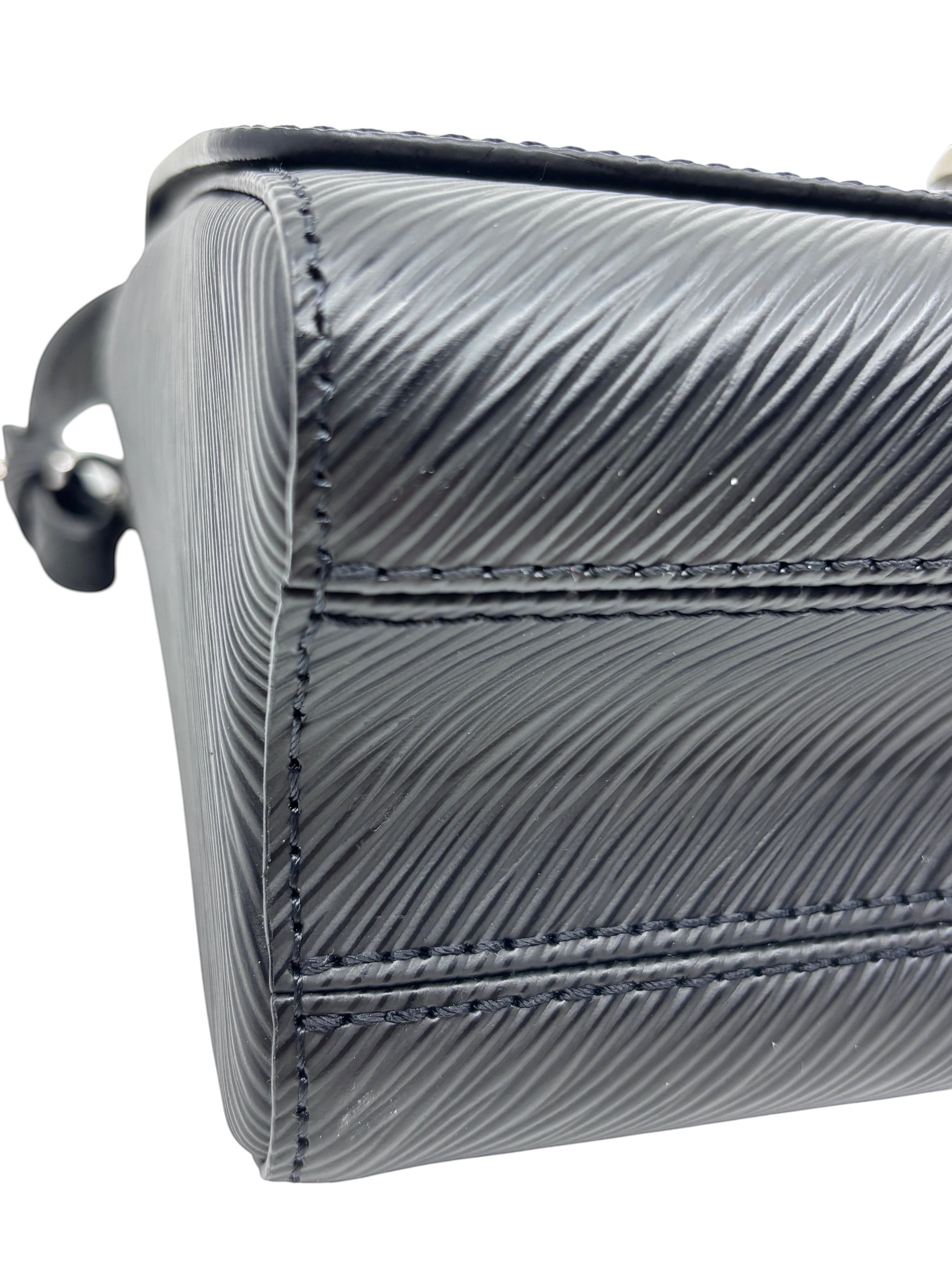 Close-up of black textured Epi leather on a Posh Purse Co Louis Vuitton Twist bag showing detailed stitching.
