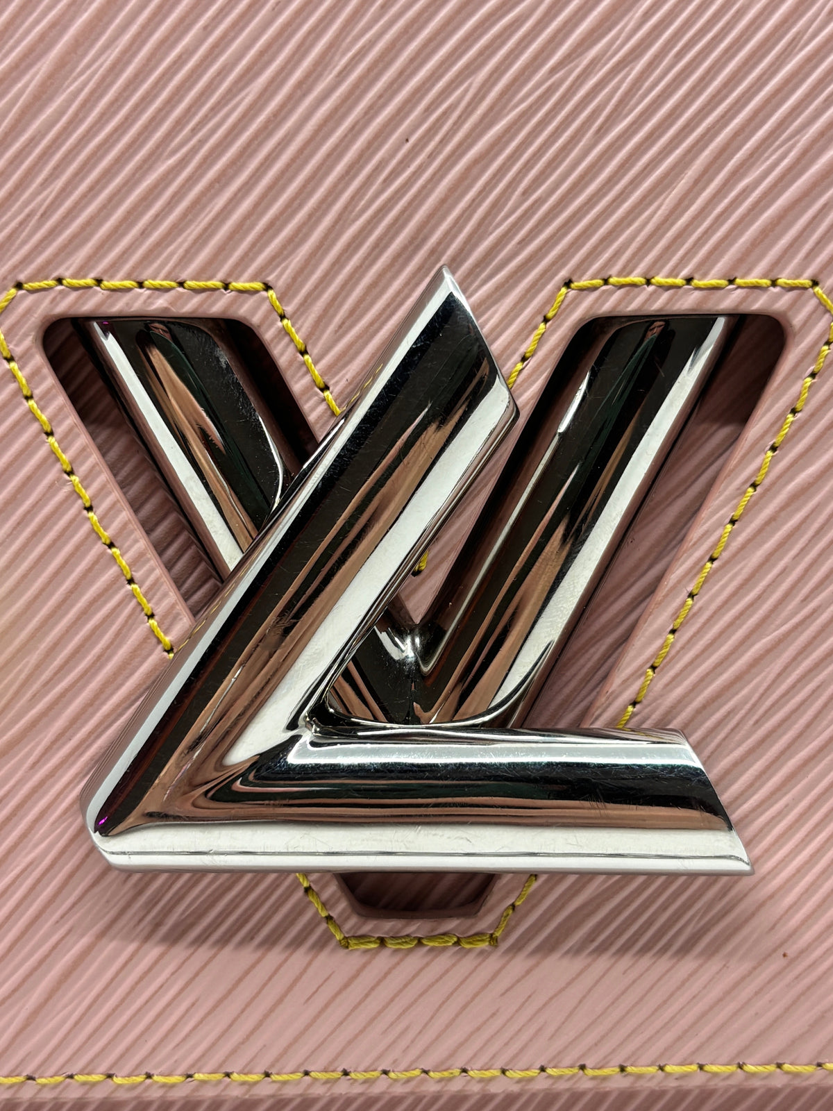 Posh Purse Co Louis Vuitton Epi leather Twist MM bag featuring a silver LV twist-lock closure on soft pink leather.