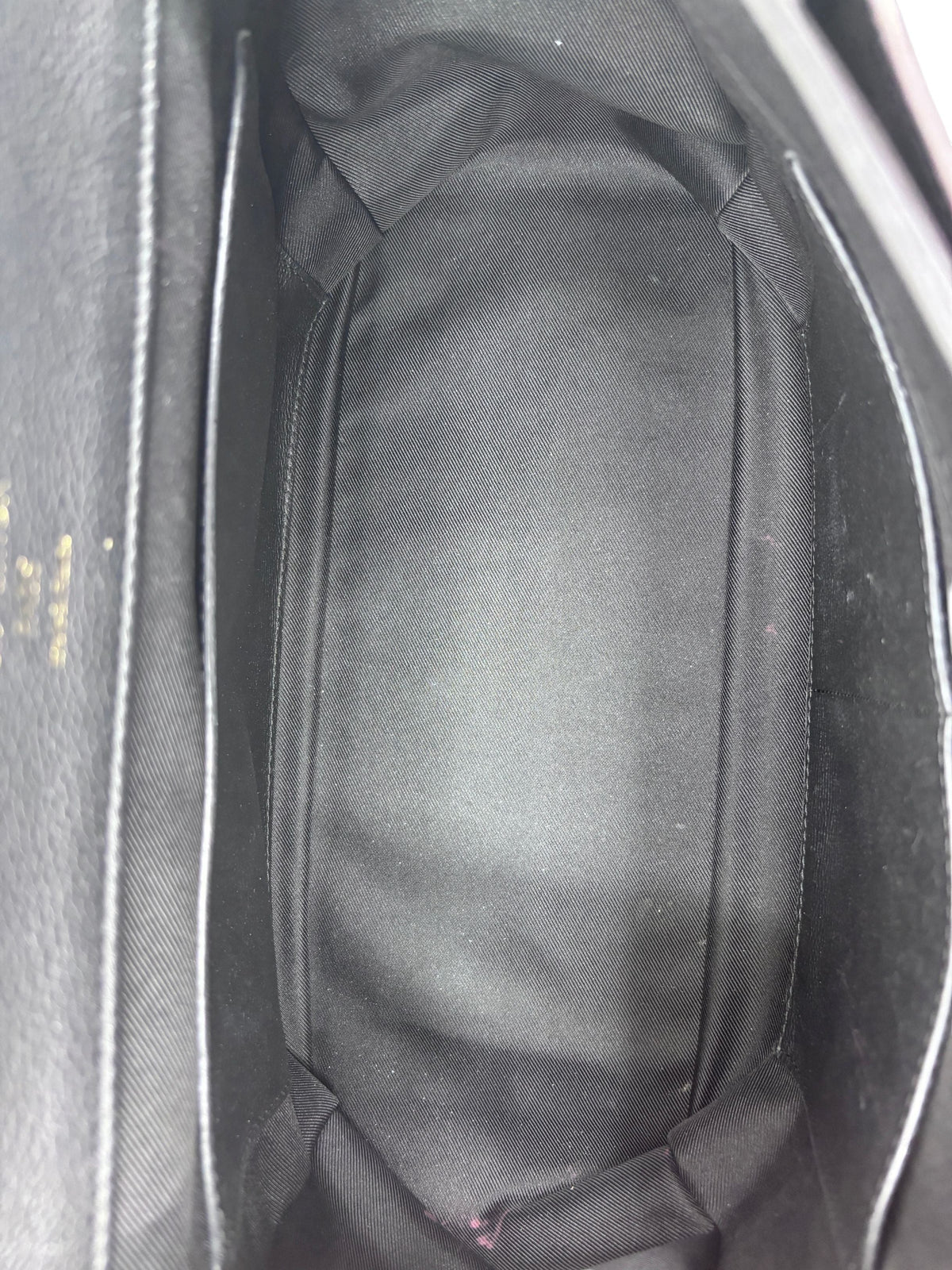 Interior view of a Posh Purse Co preloved Louis Vuitton LockMe MM handbag featuring black fabric lining.