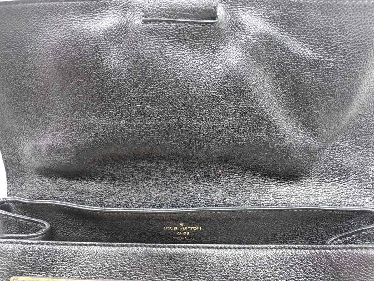 Interior of Posh Purse Co preloved Louis Vuitton LockMe MM handbag featuring black leather and gold logo stamp