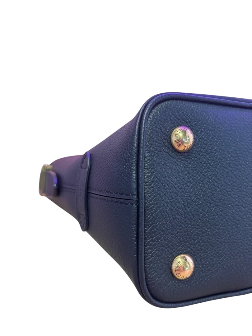Posh Purse Co. Louis Vuitton Lowkey Carryall base with gold-tone protective feet and black grained leather detail.