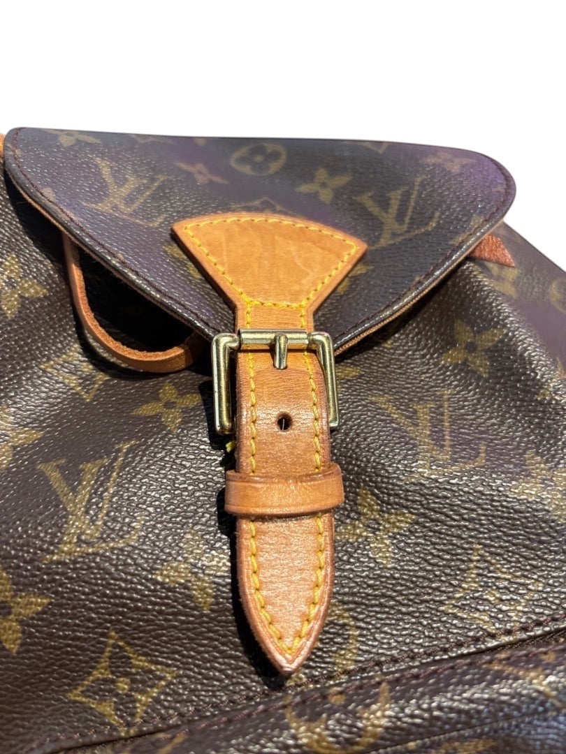 Posh Purse Co. Louis Vuitton Monogram coated canvas bucket backpack with vachetta leather trim and gold-tone buckle detail.