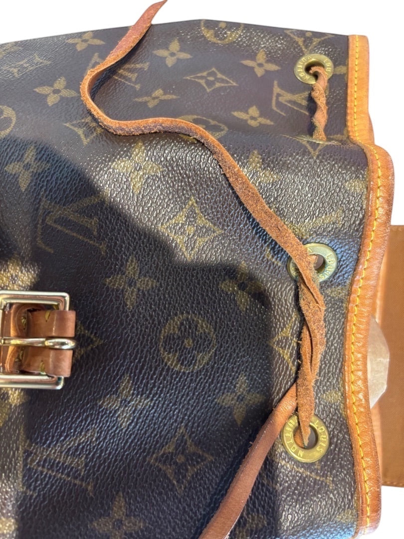 Posh Purse Co. Louis Vuitton Monogram coated canvas bucket backpack with vachetta leather trim, drawstring closure, and gold-tone hardware.