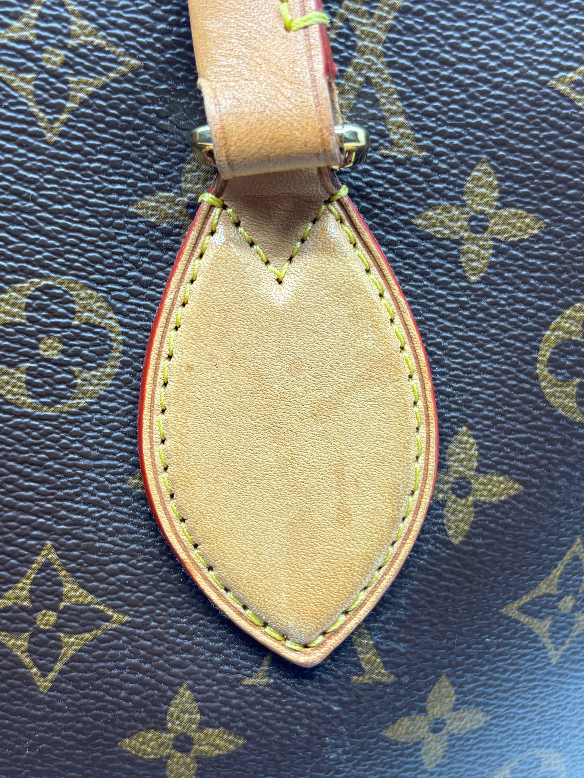Posh Purse Co Louis Vuitton Monogram canvas handbag detail showing the signature leather tab and contrast stitching