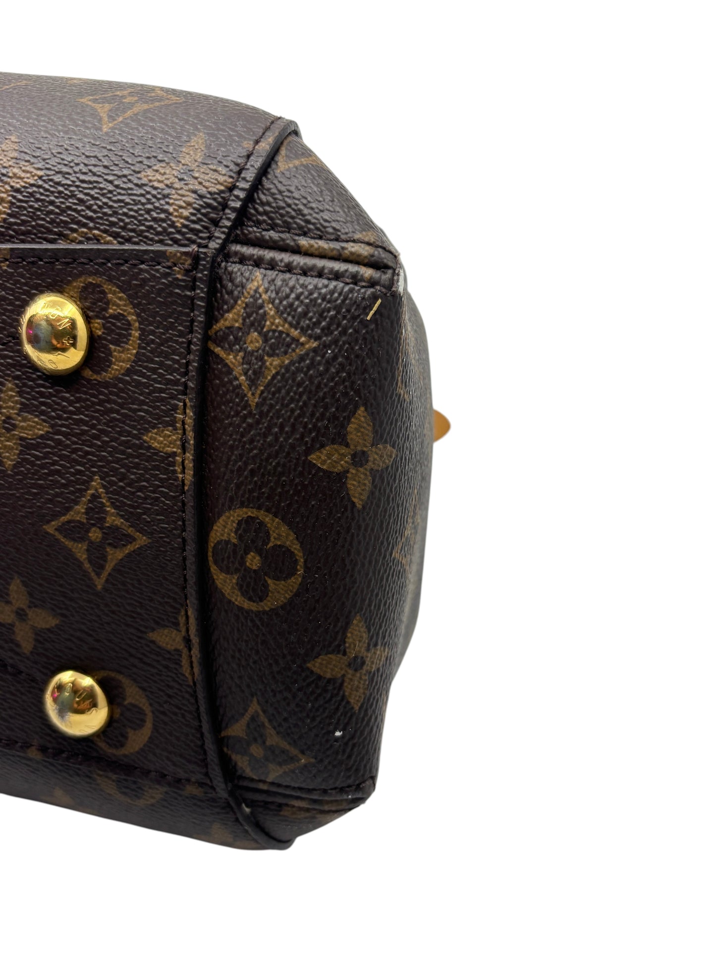 Posh Purse Co. Louis Vuitton Montaigne MM monogram canvas handbag base showing gold-tone protective feet and corner wear.