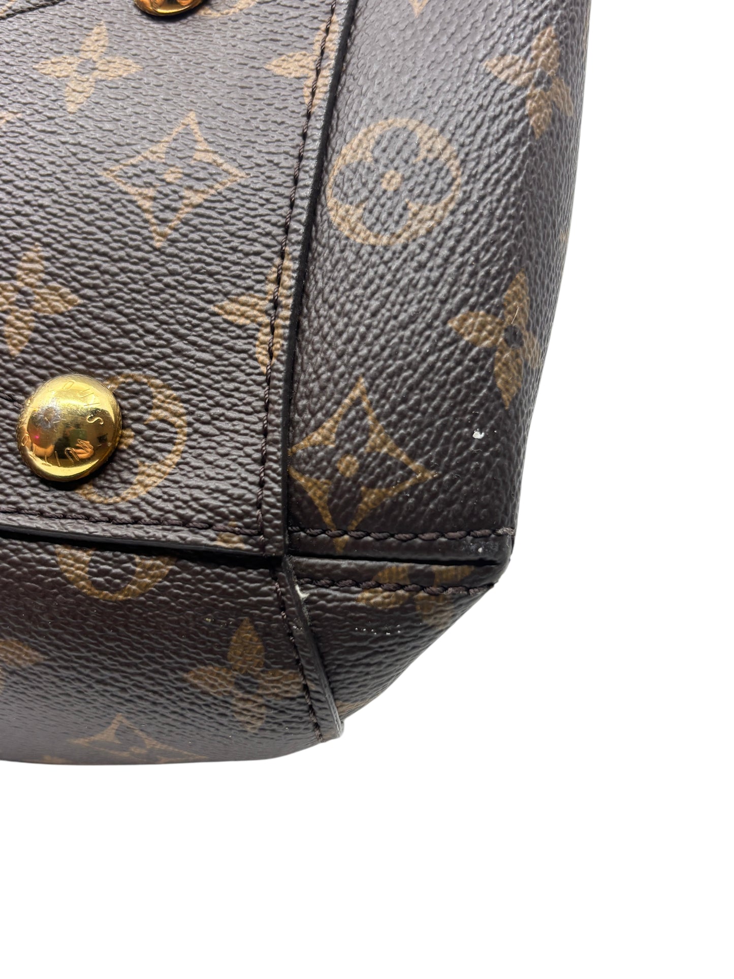 Posh Purse Co. Louis Vuitton Montaigne MM monogram canvas corner showing minor wear and gold-tone hardware detail.