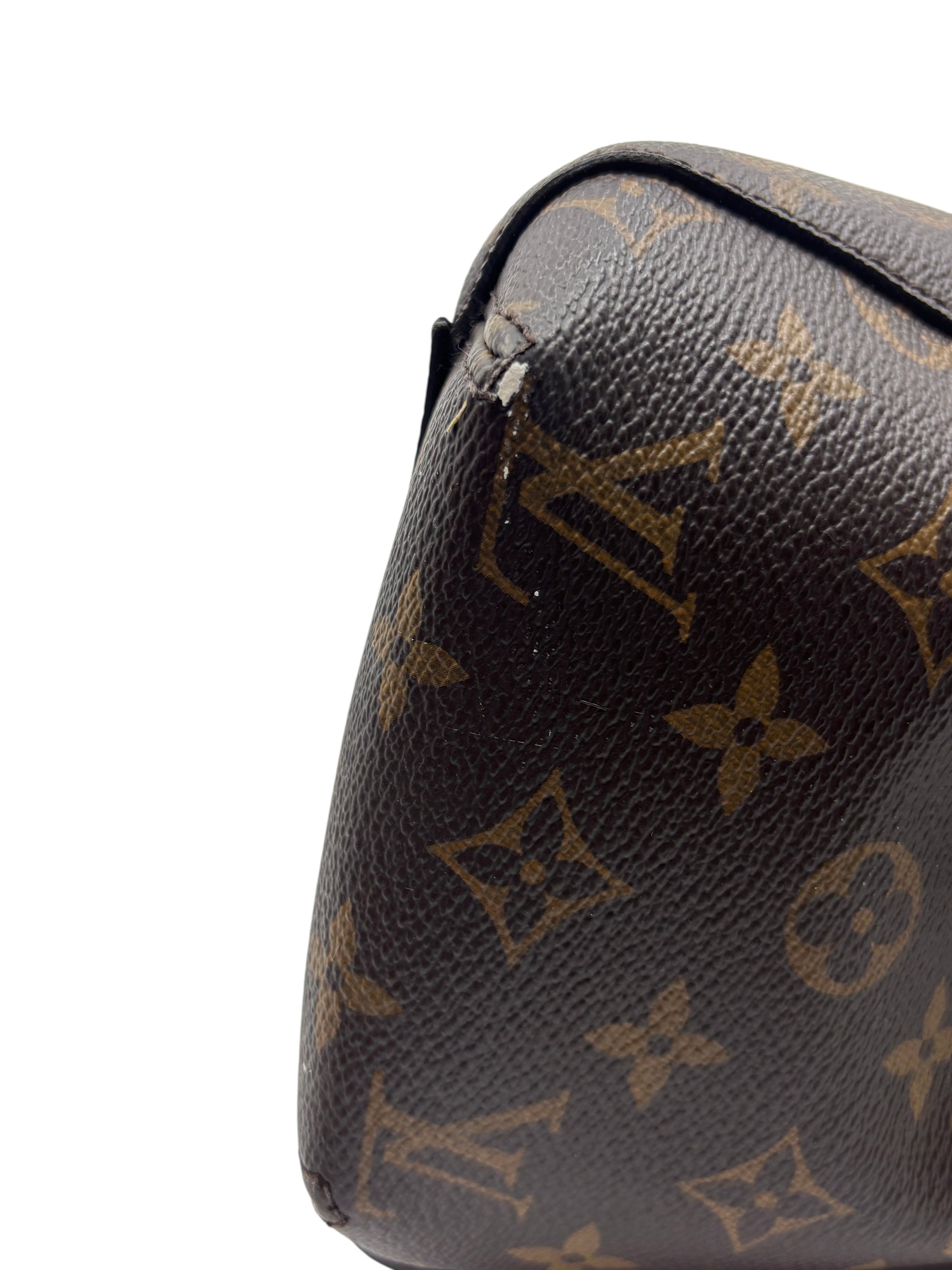 Close-up of corner wear on a Posh Purse Co. preloved Louis Vuitton Montaigne MM monogram canvas handbag