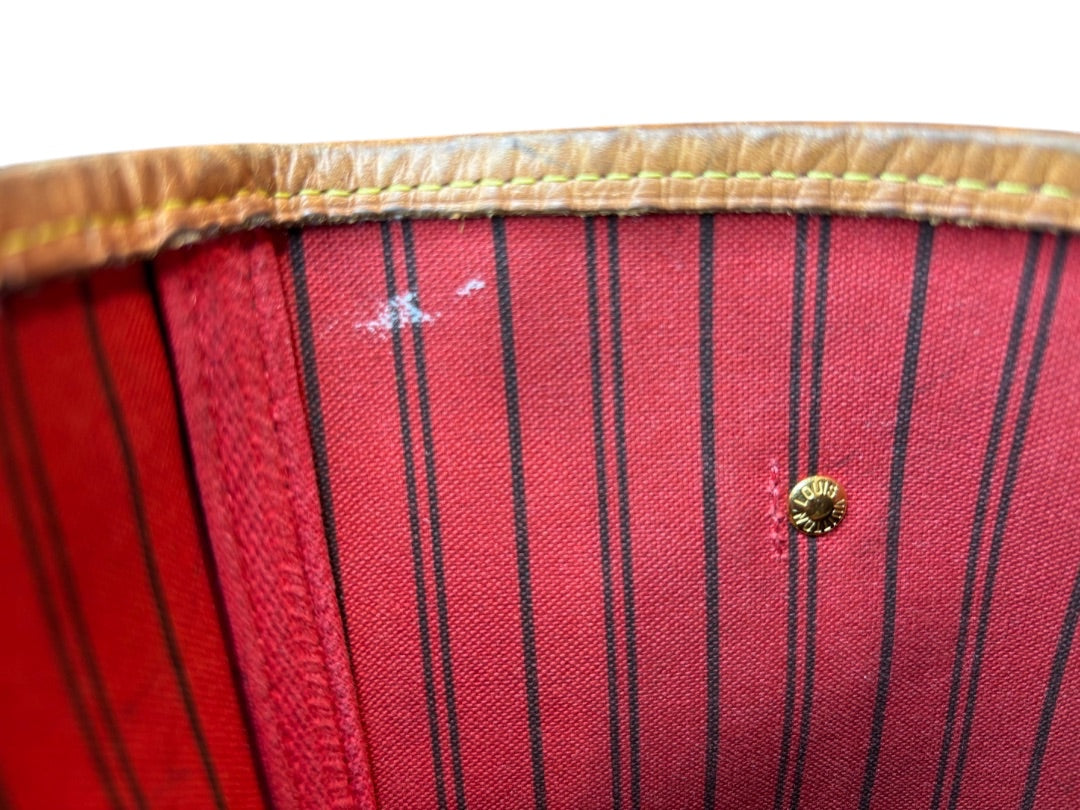 Posh Purse Co Louis Vuitton Neverfull MM interior with red striped lining, tan leather trim, and gold button detail.