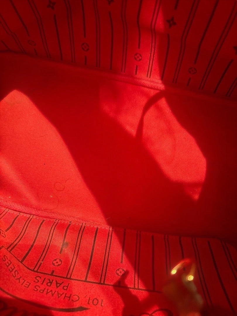 Posh Purse Co Louis Vuitton Damier Ebene Neverfull MM interior with red striped lining and gold hardware detail.