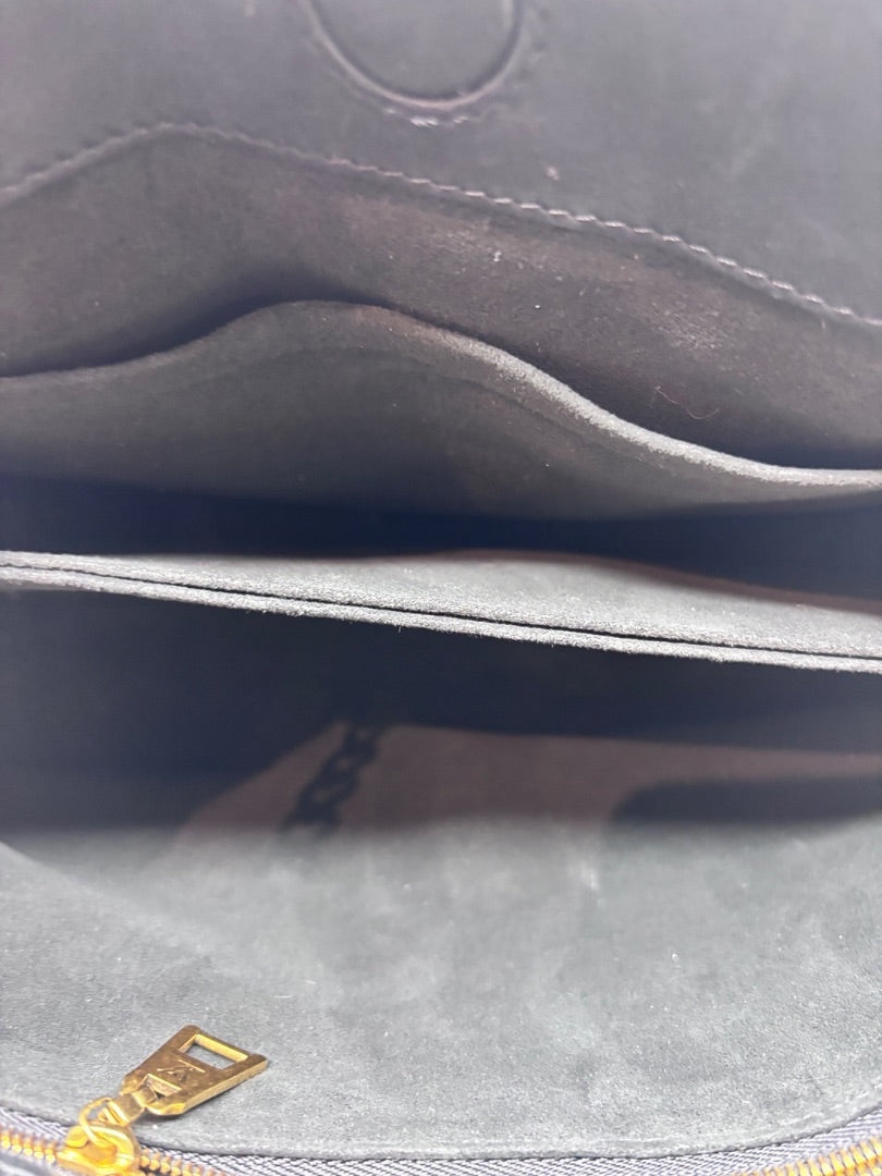 Interior view of a Posh Purse Co preloved Louis Vuitton New Wave Chain Bag showing black lining and gold zipper pull.