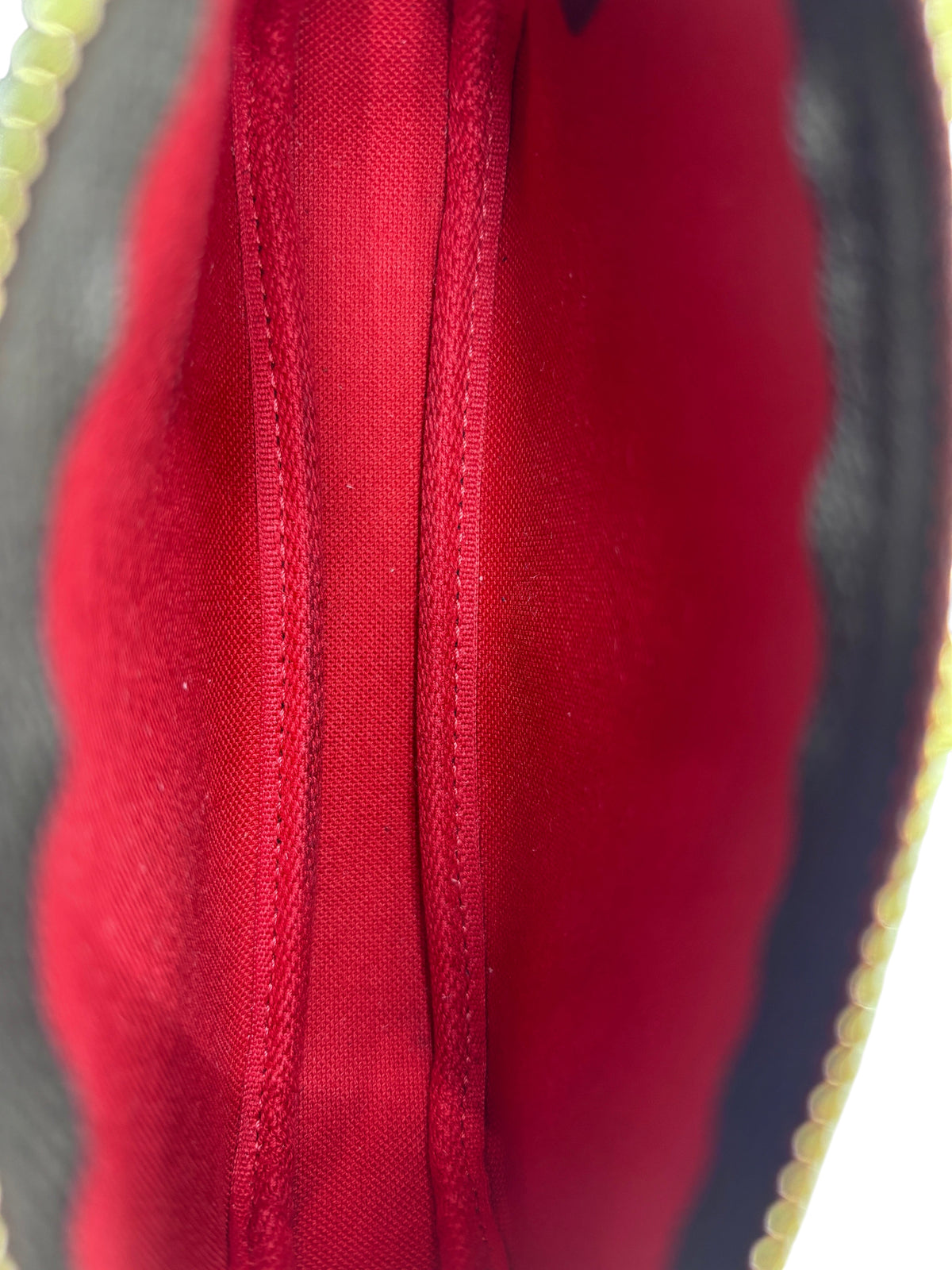 Interior view of Posh Purse Co Louis Vuitton Mini Pochette featuring vibrant red textile lining and clean stitching