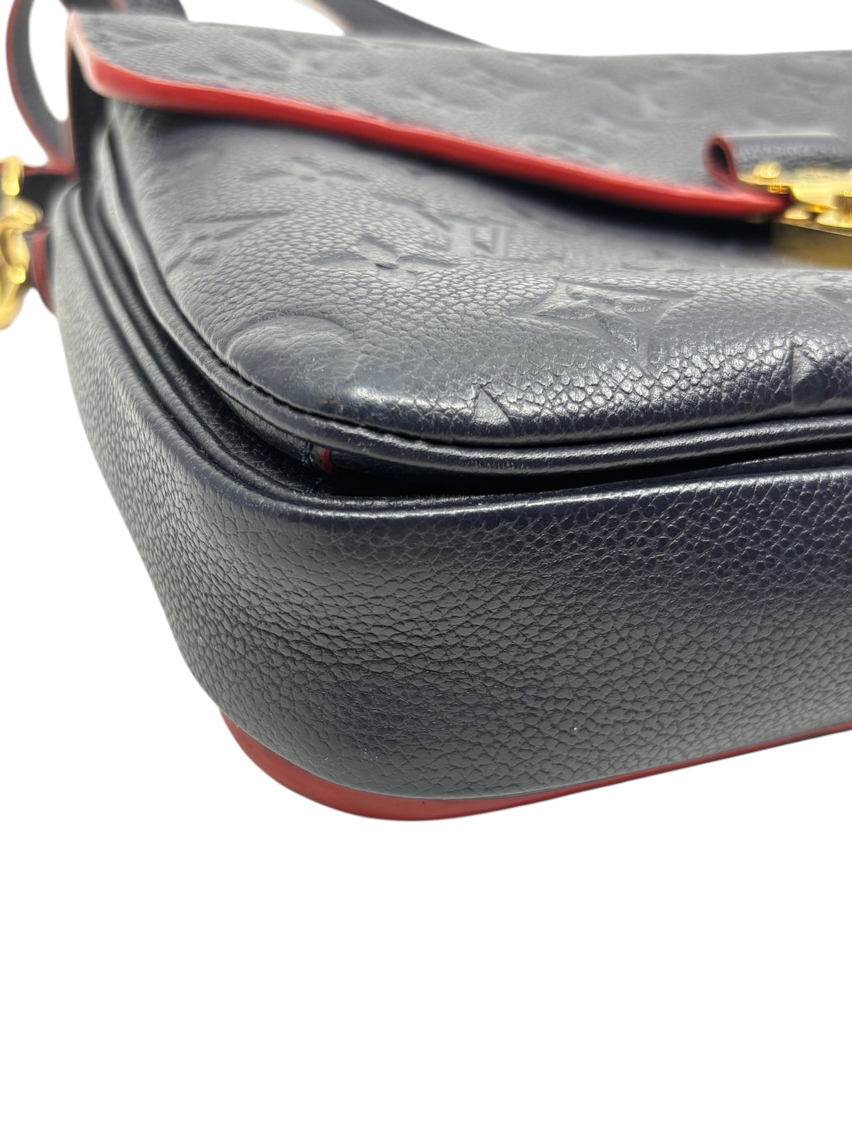 Posh Purse Co. Louis Vuitton Pochette Metis in navy embossed Monogram Empreinte leather with red trim detail.